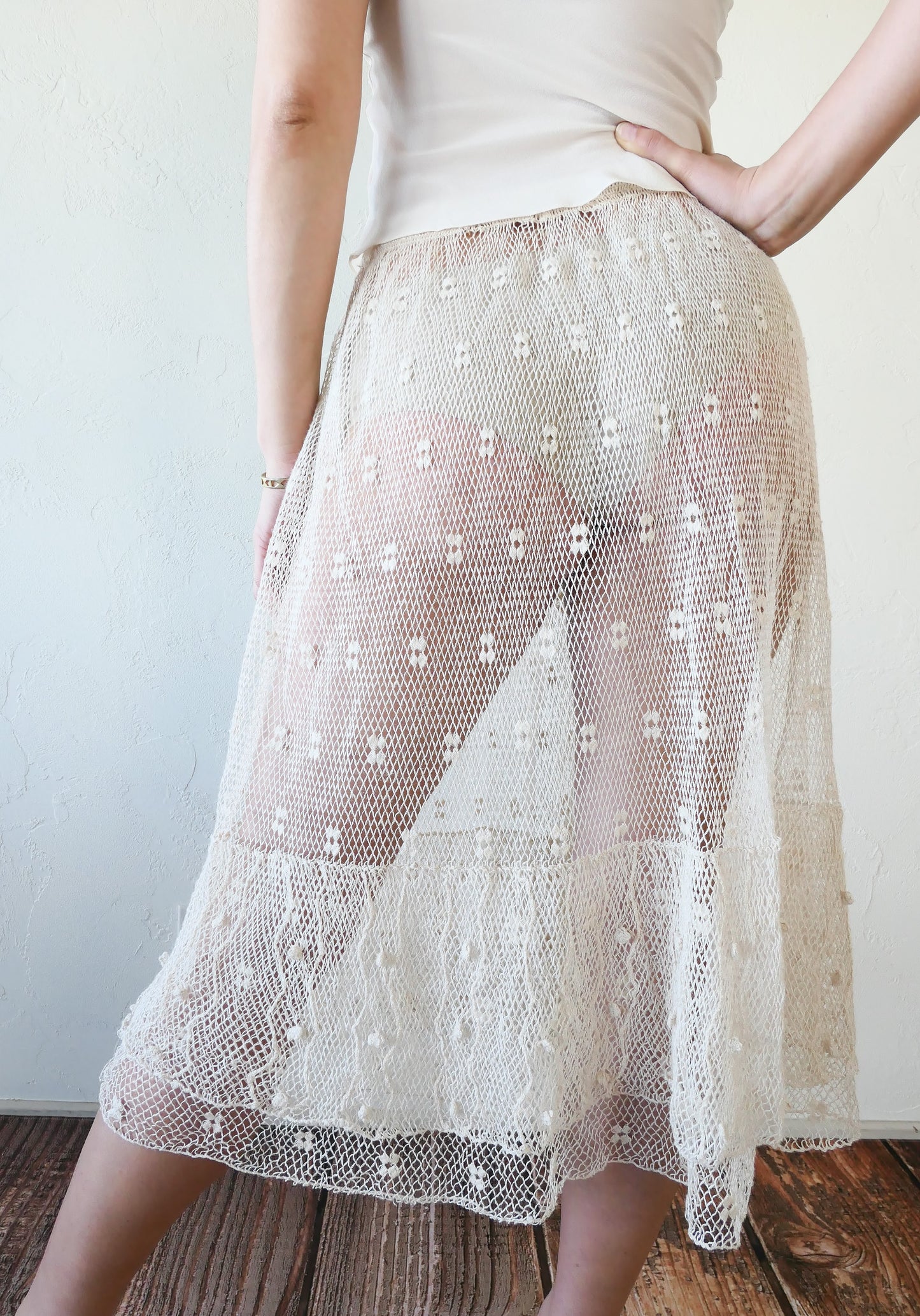 Like the delicate petals of the California Poppy, this skirt wafts and floats like a gentle summer breeze. Made with a delicate fishnet crochet, dotted with mini florettes, and accented with a two-tiered ruffle hem, this dress is sure to sweep you off your feet! Comes with a comfortable fitting elastic waistband that rests easily on the waist. Great as a beach coverup with a pair of wedgy sandals, a cute straw hat, and a mojito in hand. Size: Fits small to medium