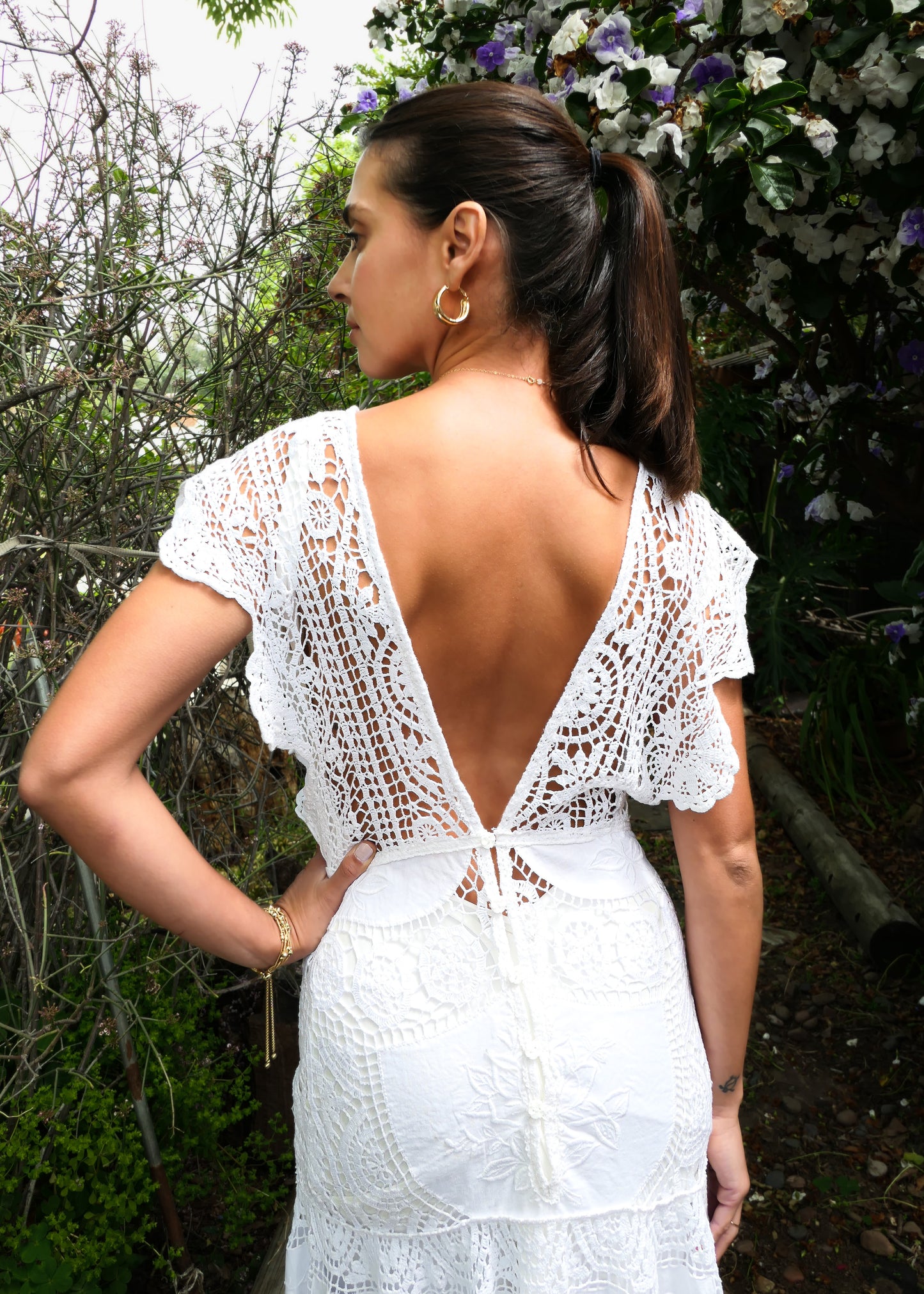 A romantic and elegantly seductive V-neck and V-back hand crocheted and embroidered patchwork maxi dress made with our signature Lim's Vintage fabric. This dress is fitted and flared at all the right places, accentuating your natural curves and perfect for your special wedding day or stylish summer beach party. Does not come with a slip, but we highly recommend wearing one due to the "holey" nature of the crochet. Color: White. Can be made to order.