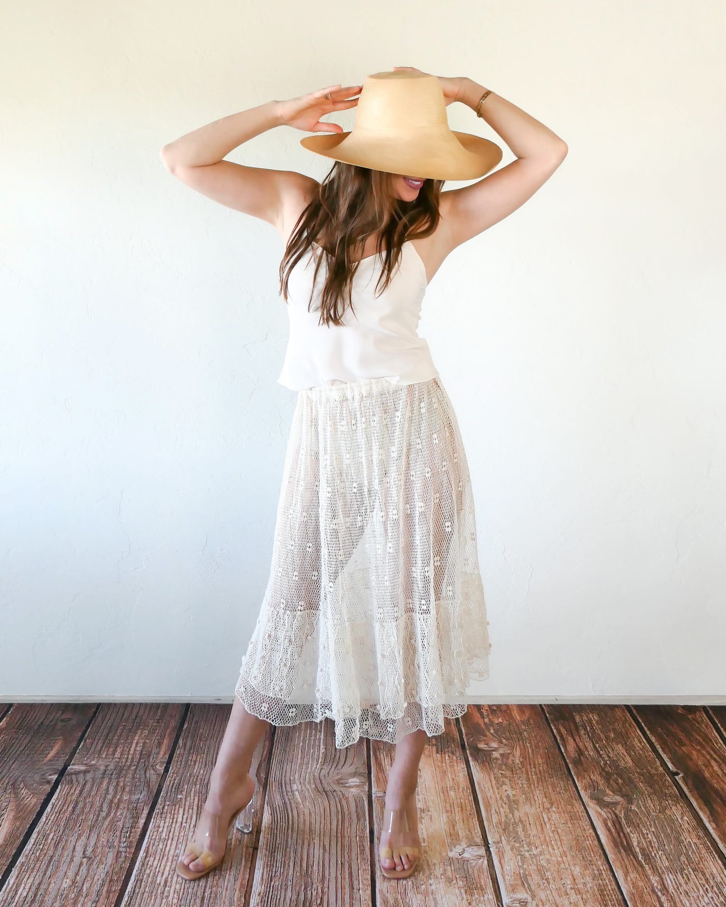 Like the delicate petals of the California Poppy, this skirt wafts and floats like a gentle summer breeze. Made with a delicate fishnet crochet, dotted with mini florettes, and accented with a two-tiered ruffle hem, this dress is sure to sweep you off your feet! Comes with a comfortable fitting elastic waistband that rests easily on the waist. Great as a beach coverup with a pair of wedgy sandals, a cute straw hat, and a mojito in hand. Size: Fits small to medium