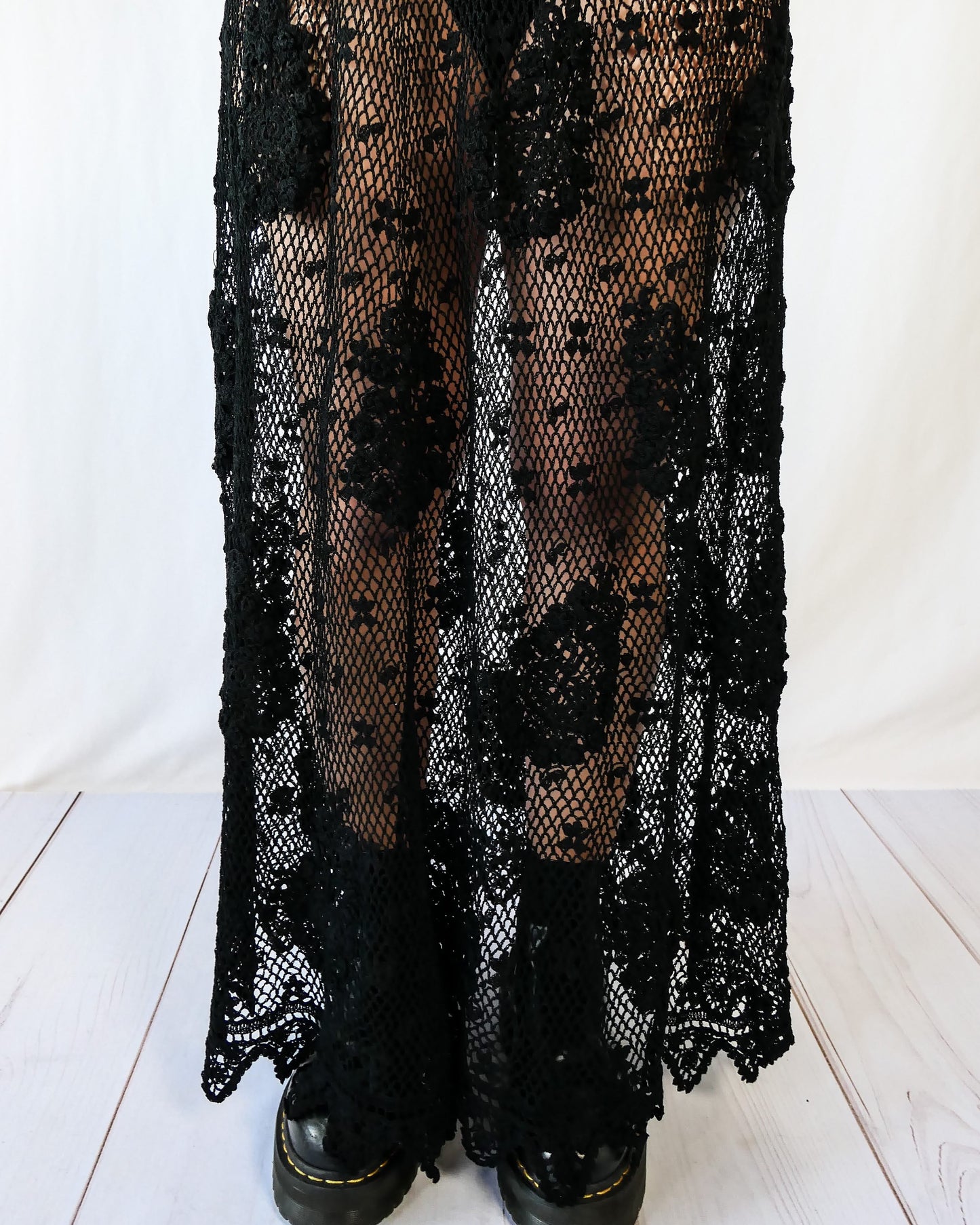 Hand crocheted, lightweight, flowy maxi length slip-on skirt with a comfortable elastic waist and a paisley and floral motif throughout. Makes for a great beach coverup! This is one of our original Lim’s crochet skirts from the 1990s. Measurements: X-Small to Small: Waist 22"- 28" Length 38" Hip 46" Medium to Large: Waist 28"- 36" Length 38" Hip 50" Color: Black Material: 100% cotton