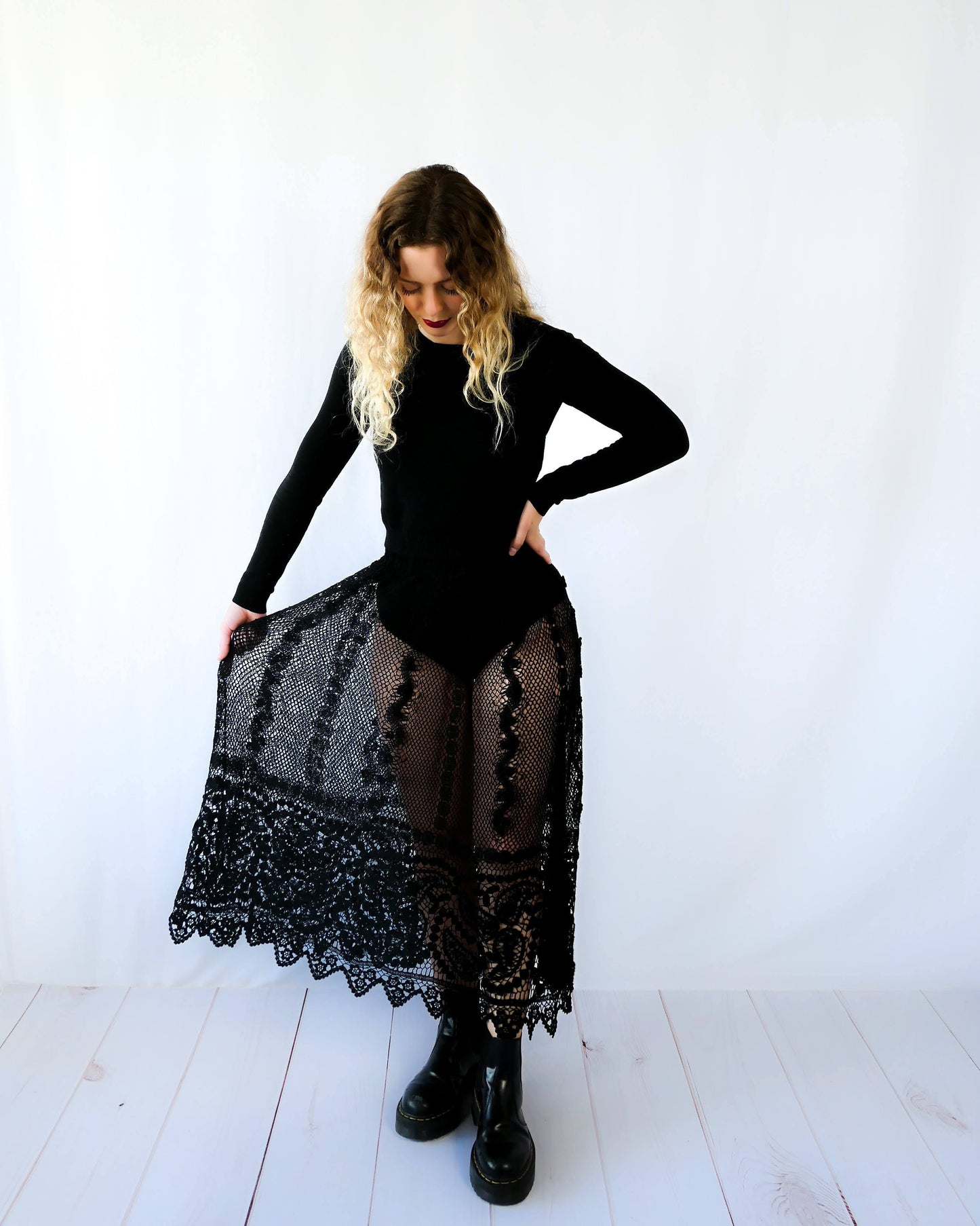 Fall in love again with this original Lim's bohemian, whimsical black hand crocheted, maxi length skirt. Lovely paisley motif at the bottom hem, with vertical lines throughout the dress composed of intricate pinwheel-like circles and squiggly lines dotted with flowers. Looks stunning paired with a black silk camisole and bikini shorts, or a black sweater or crop top and a pair of boots. Size: Fits Small to Medium Measurements: Waist 26"- 30" Length 38" Hip 55” Color: Black Material: 100% cotton