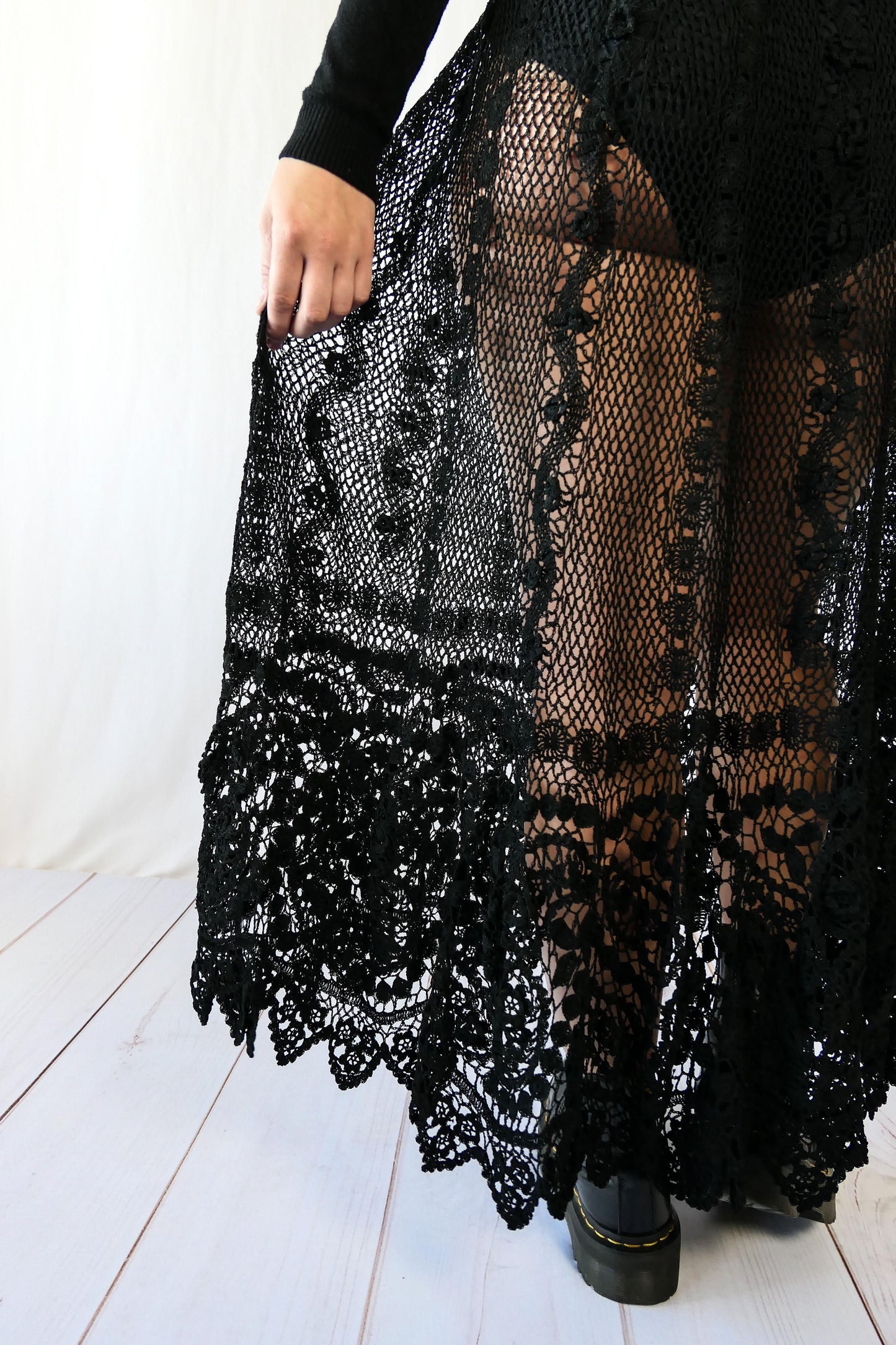 Fall in love again with this original Lim's bohemian, whimsical black hand crocheted, maxi length skirt. Lovely paisley motif at the bottom hem, with vertical lines throughout the dress composed of intricate pinwheel-like circles and squiggly lines dotted with flowers. Looks stunning paired with a black silk camisole and bikini shorts, or a black sweater or crop top and a pair of boots. Size: Fits Small to Medium Measurements: Waist 26"- 30" Length 38" Hip 55” Color: Black Material: 100% cotton