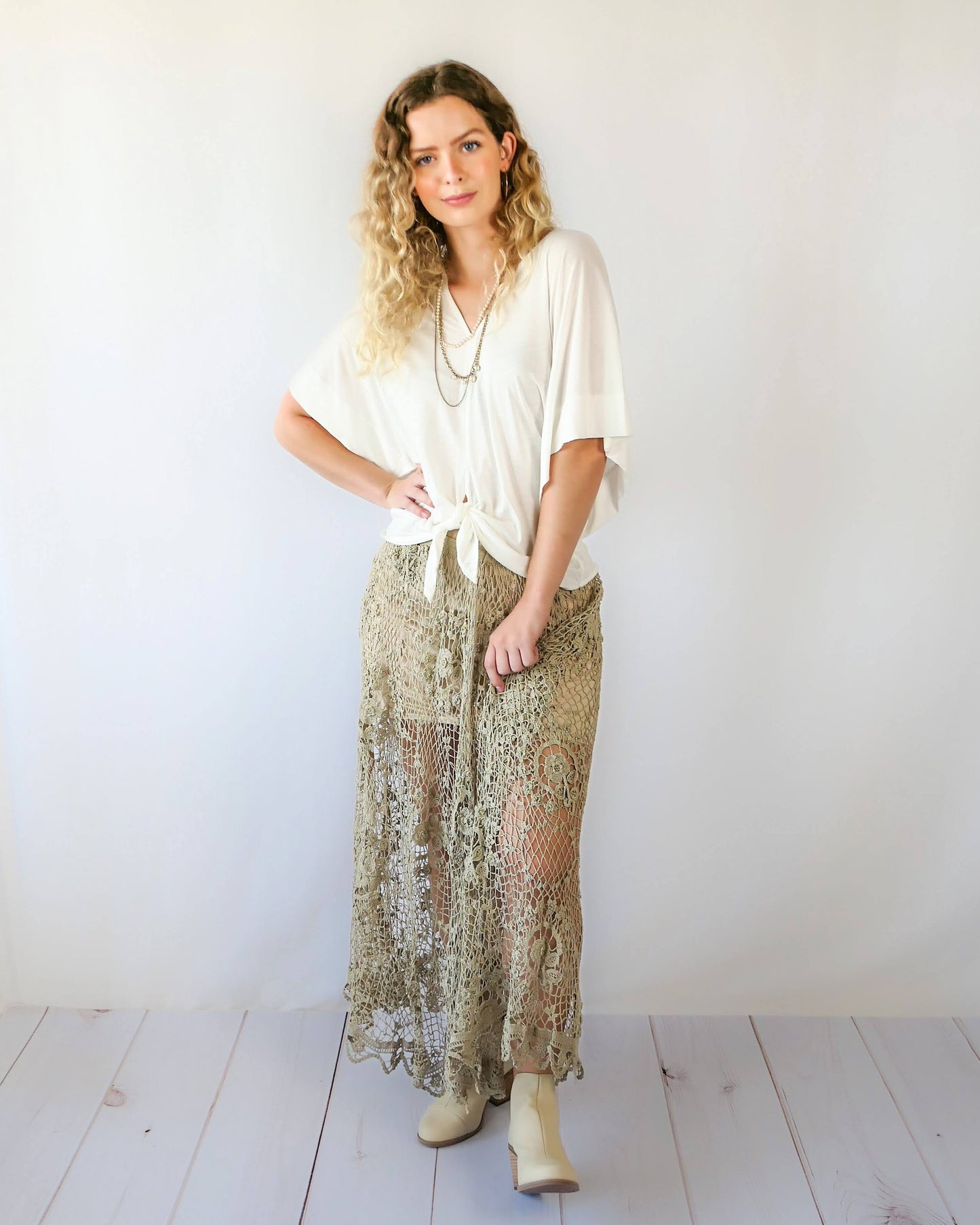 The ultimate cowgirl romantic hand crocheted maxi skirt with a circular floral design against a fishnet-like backdrop. This is an original Lim's piece from the 1980s and is truly a vintage collector's item!