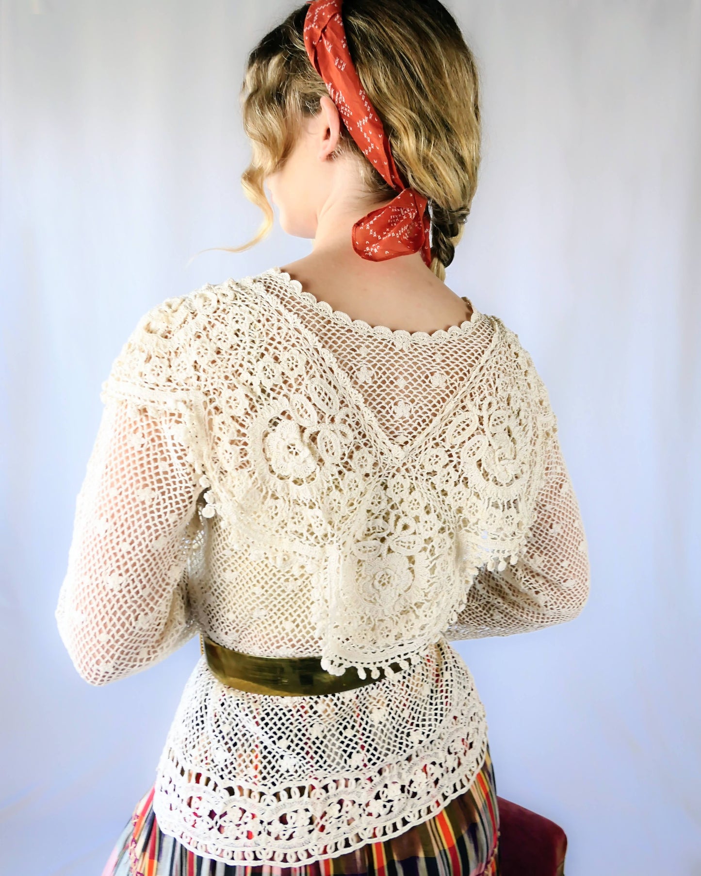 Back view of top. A cottagecore crew neck long sleeve top with intricate hand crocheted floral detail at the collar, hem, and sleeves. This timeless piece is an original Lim's top from the1980s and in excellent condition. Natural color.