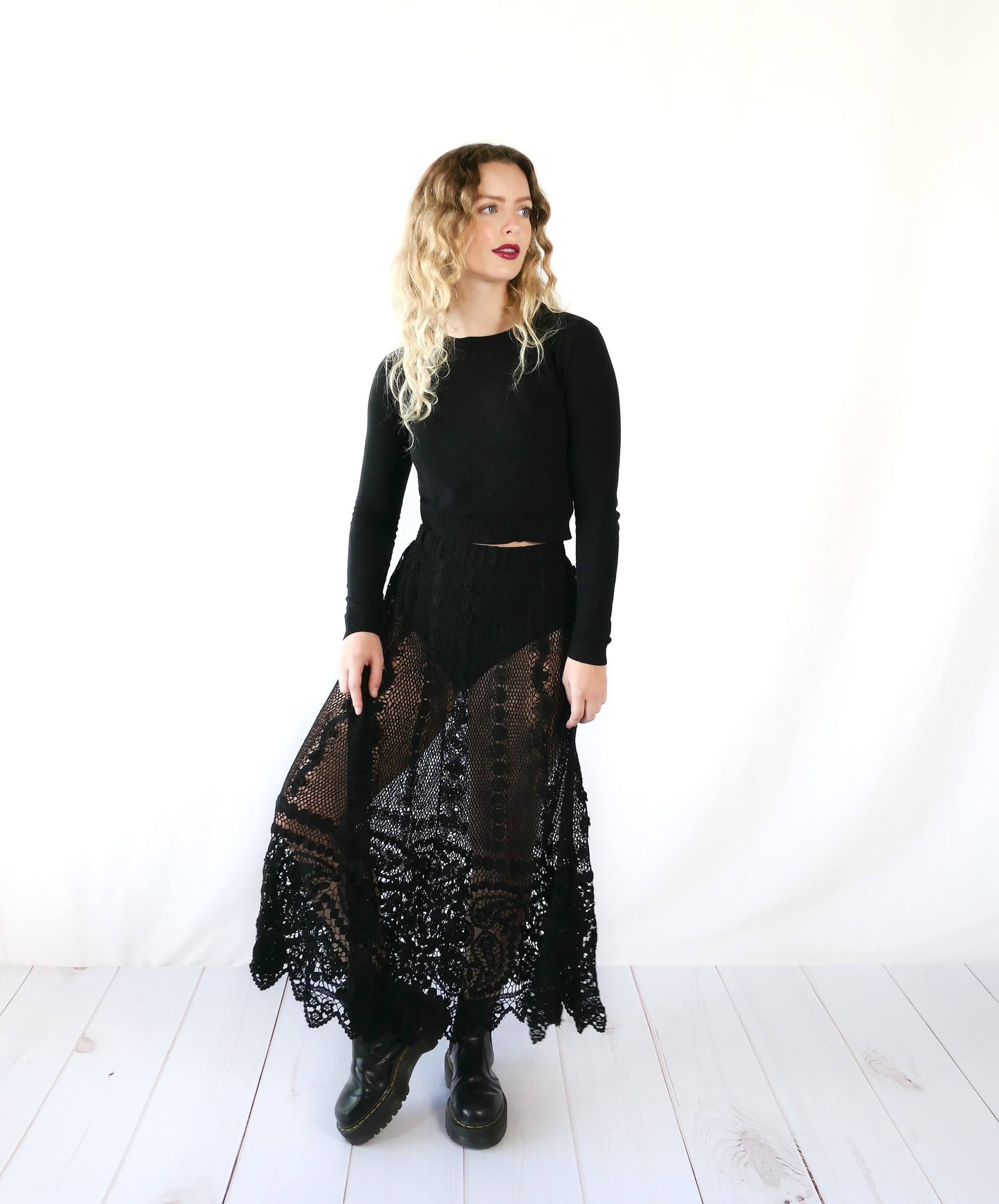 Fall in love again with this original Lim's bohemian, whimsical black hand crocheted, maxi length skirt. Lovely paisley motif at the bottom hem, with vertical lines throughout the dress composed of intricate pinwheel-like circles and squiggly lines dotted with flowers. Looks stunning paired with a black silk camisole and bikini shorts, or a black sweater or crop top and a pair of boots. Size: Fits Small to Medium Measurements: Waist 26"- 30" Length 38" Hip 55” Color: Black Material: 100% cotton