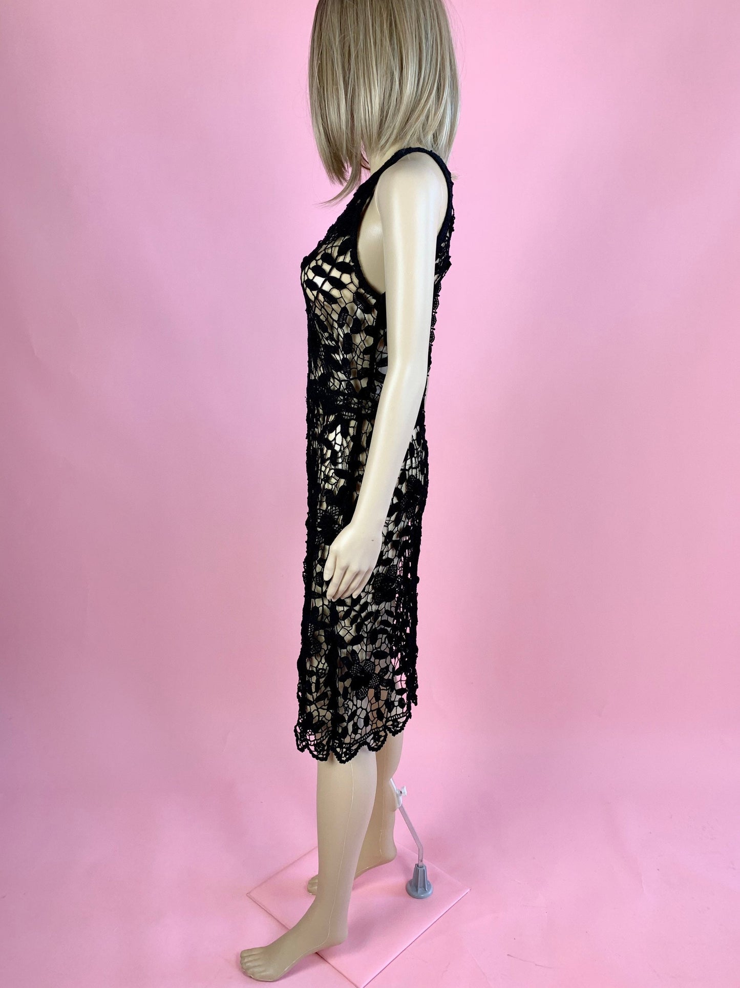 Lim's Vintage black crochet sleeveless halter midi dress with leaf and floral motif and zig-zag hem. The top is reversible and can be worn with buttons going down the front or back. Elastic waistband connects the top and bottom of the dress.