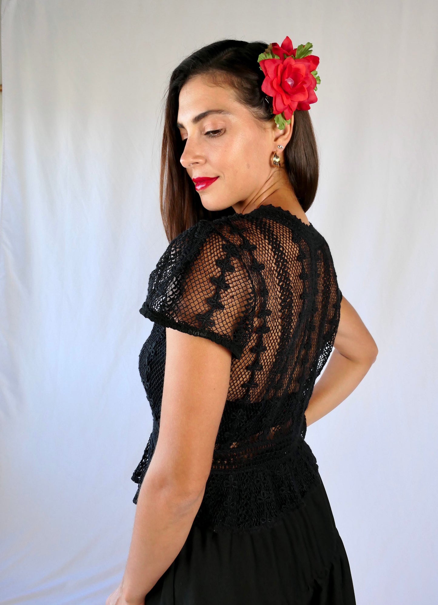 Delicate mesh pattern hand crocheted short puff sleeve top in black with a high waist and flared hem. This is a Lim’s original vintage piece from the 1980s with trim added recently to finish the hem. The top is reversible and can be buttoned up the front or back.
