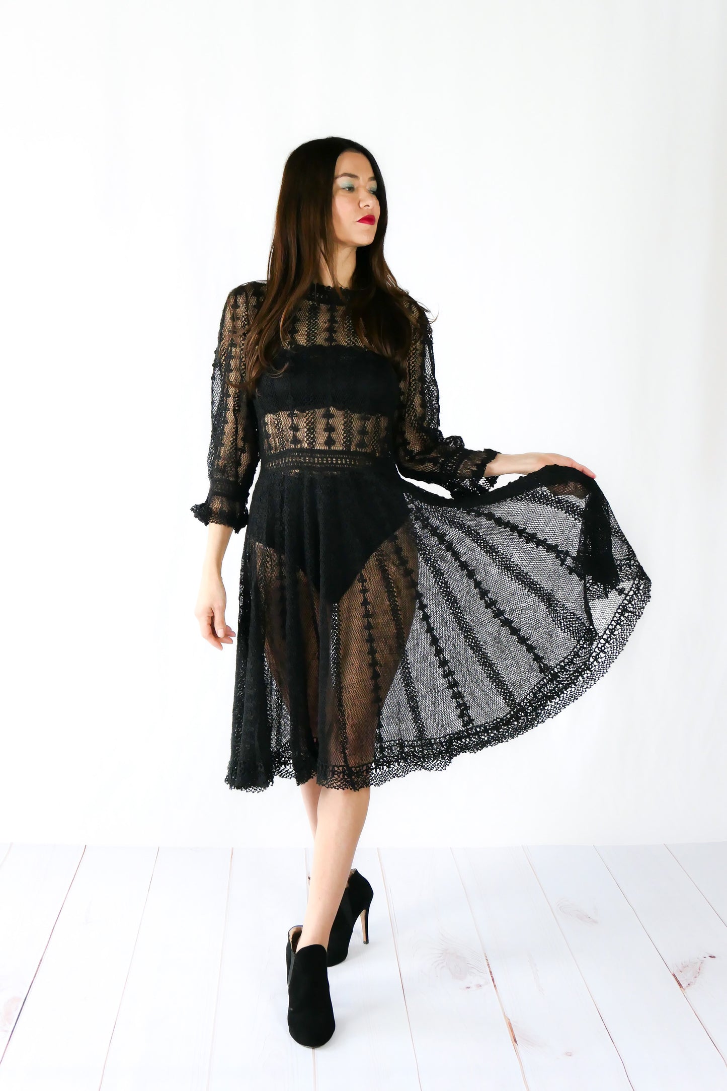 A beguiling black version of our cottage core style midi length crochet dress, this dreamy Lim's original vintage piece from the 1980s is made with very fine threads, creating a refined and sheer look. Detailed crochet trim is used at the waist, hemline, and 3/4 length ruffled sleeves. Measurements: Bust 36” Waist 30” Length 42” Shoulder width 15” Sleeve 20” Cuff circumference 9" Color: Black