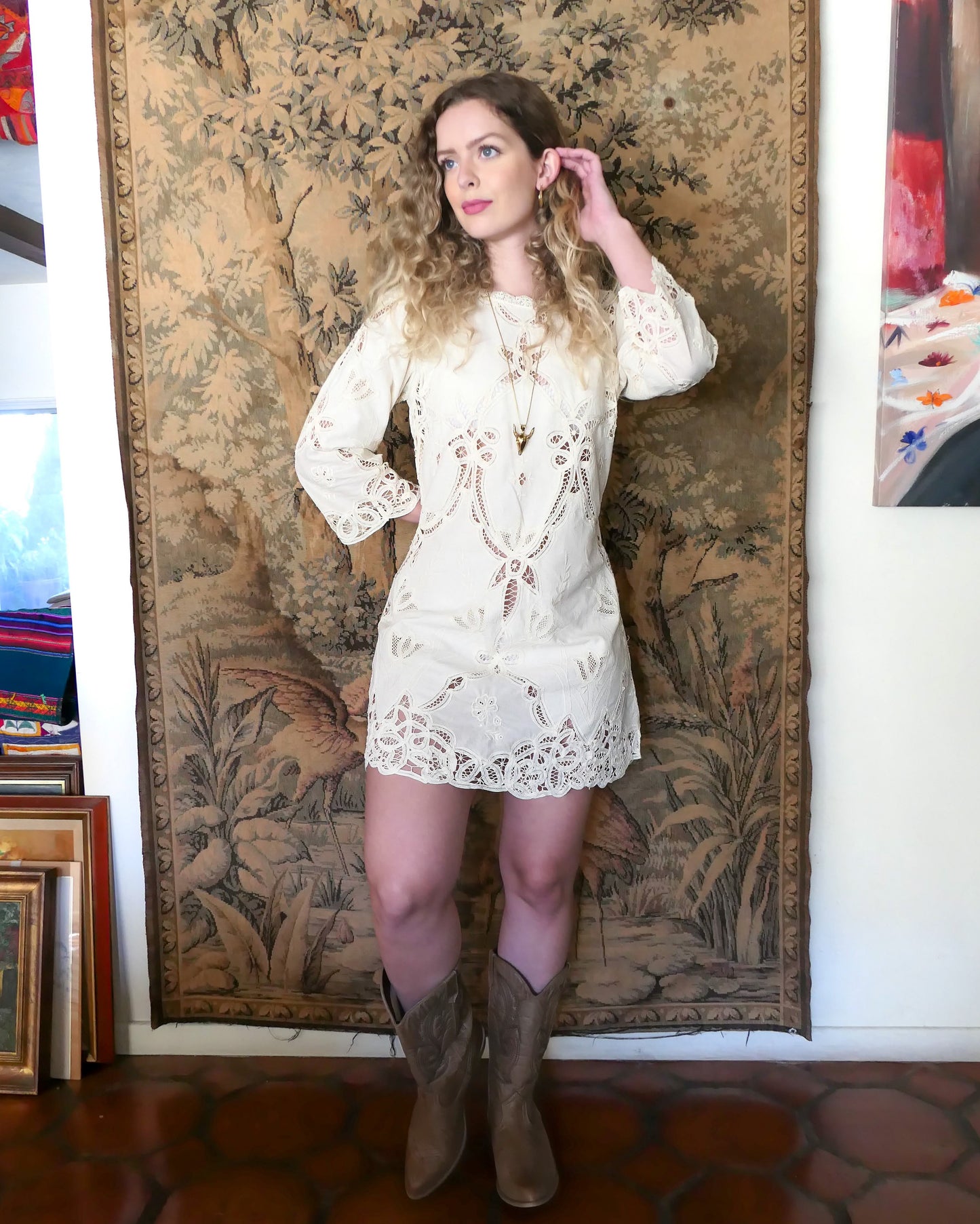A charming Lim's Vintage Battenberg lace mini dress with a cutout and embroidered tulip and flower motif throughout. Buttons up the back and slips on easily for a comfortable fit. The dress can easily be altered depending on individual size requirements. Goes splendidly with a pair of vintage cowboy boots. Size: Fits Medium to Large Measurements: Bust 38" Waist 36" Sleeve 20" Shoulder width13" Length 33" Hip 46" Color: Natural Material: 100% Cotton