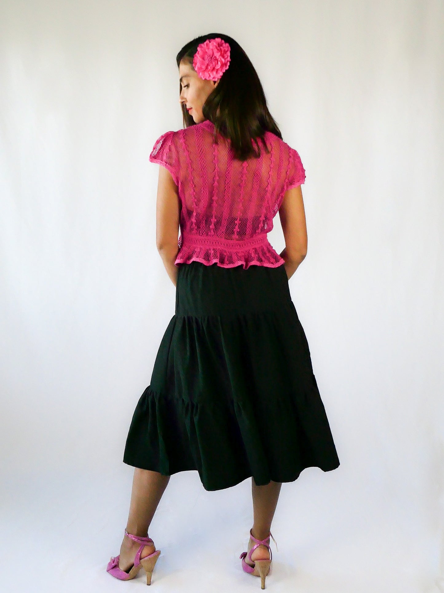 Delicate mesh pattern hand crocheted short puff sleeve top in a pretty fuschia pink! This top has a high waist and flared hem. This is a Lim’s original vintage piece from the 1980s with trim added recently to finish the hem. The top is reversible and can be buttoned up the front or back.