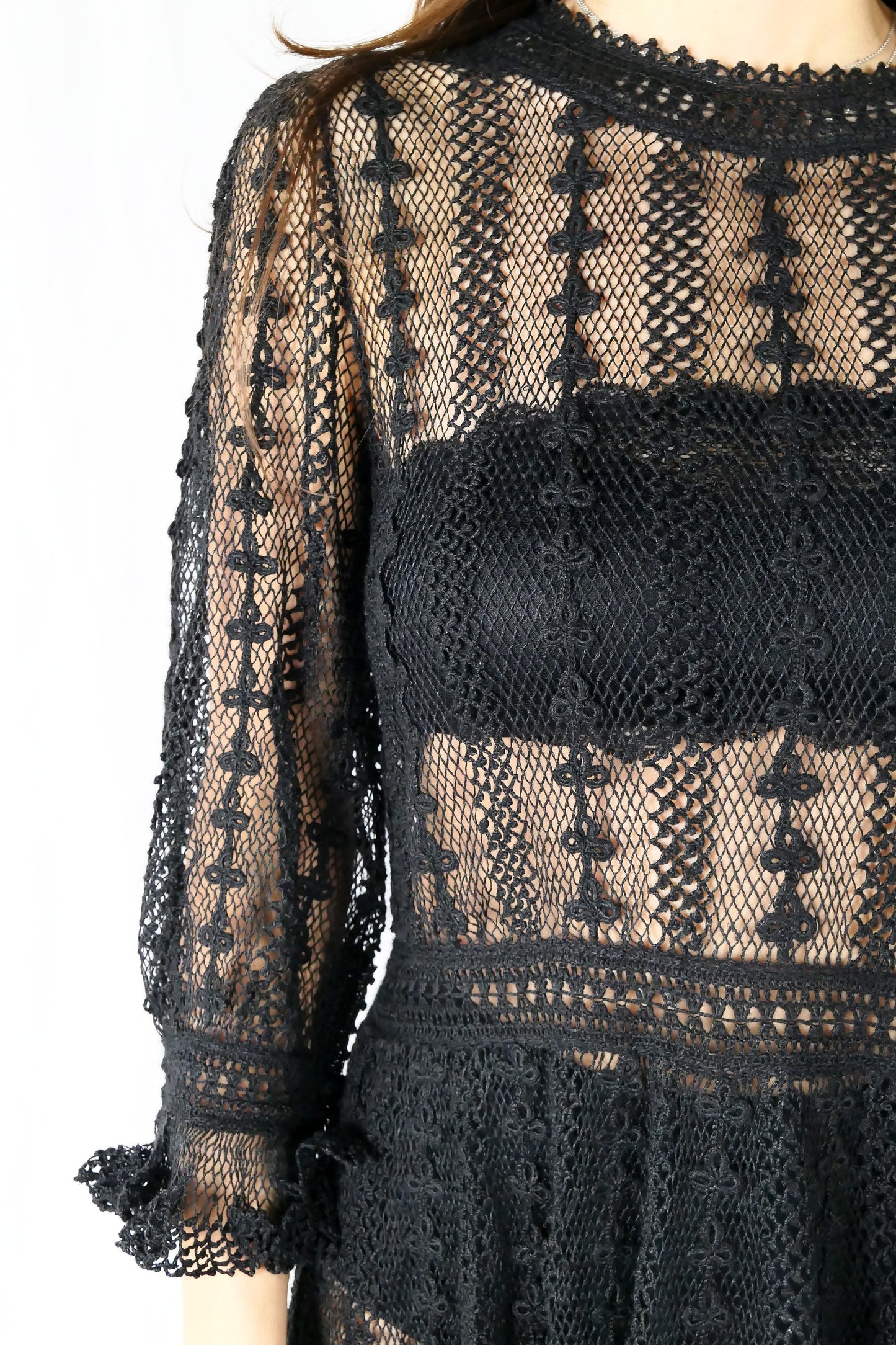 A beguiling black version of our cottage core style midi length crochet dress, this dreamy Lim's original vintage piece from the 1980s is made with very fine threads, creating a refined and sheer look. Detailed crochet trim is used at the waist, hemline, and 3/4 length ruffled sleeves. Measurements: Bust 36” Waist 30” Length 42” Shoulder width 15” Sleeve 20” Cuff circumference 9" Color: Black