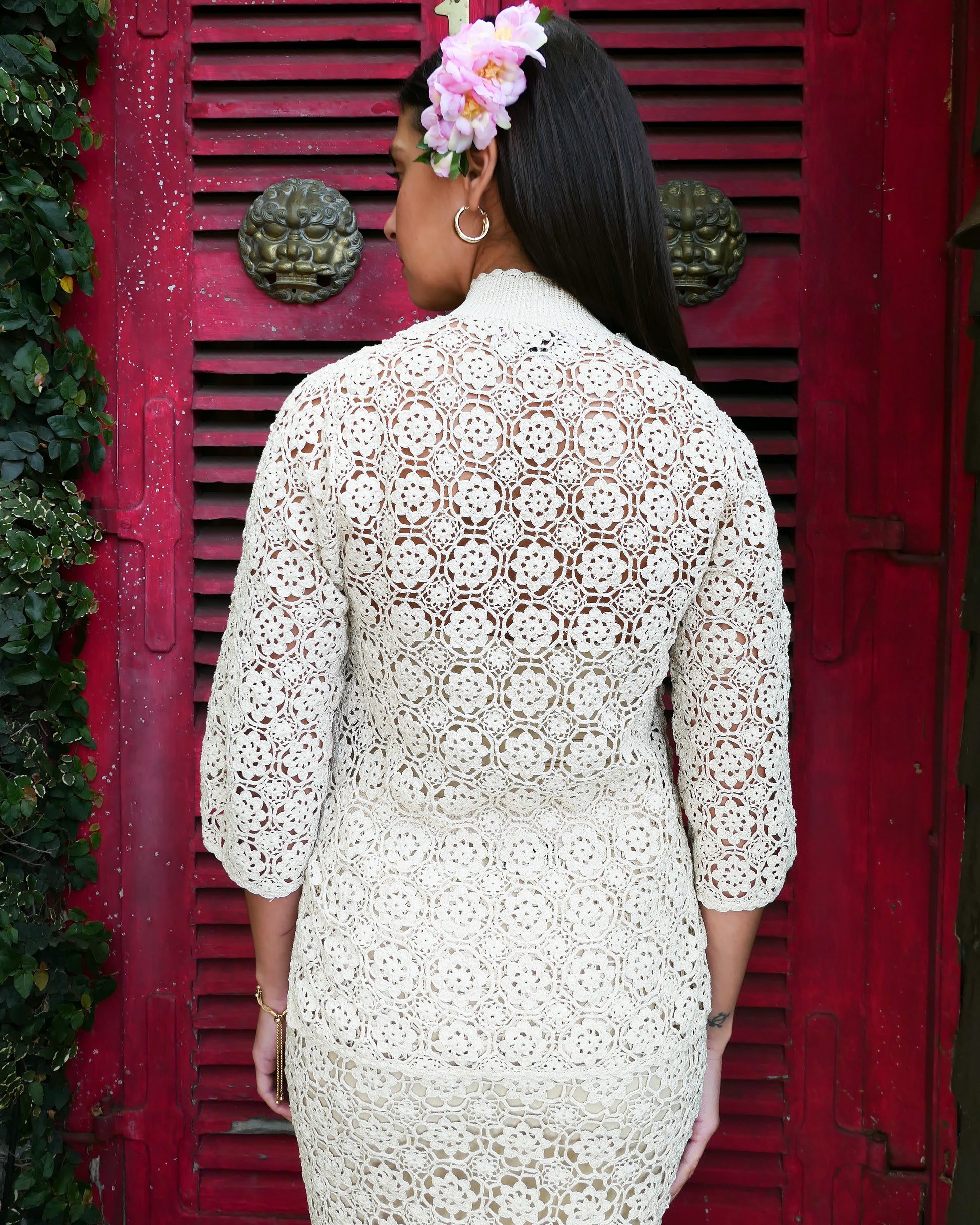 Closeup back view of top. An intricately hand crocheted top and skirt set reminiscent of the traditional Chinese Qipao, with its high mandarin collar, traditional knotted buttons that run along the front and side of the top, and the side slits that run up either side of the skirt. Simple, refined, beautiful, and one of our classic Lim's Vintage bestsellers. Color: Natural