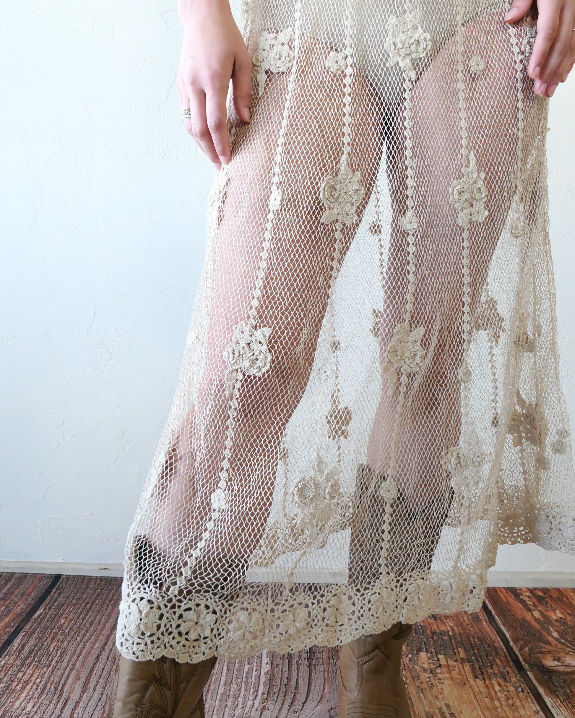 A classic Lim's crochet fishnet tank maxi dress in Natural with vertical stripes and dainty floral clusters throughout. Versatile, lightweight, and an easy pullover dress that is reversible and can be worn with the buttons in the front or back. Perfect as a beach coverup, with boots and a cowgirl hat for that boho chic appeal or worn with a neutral slip and heels for a more sophisticated look. Size: Fits Small to Medium