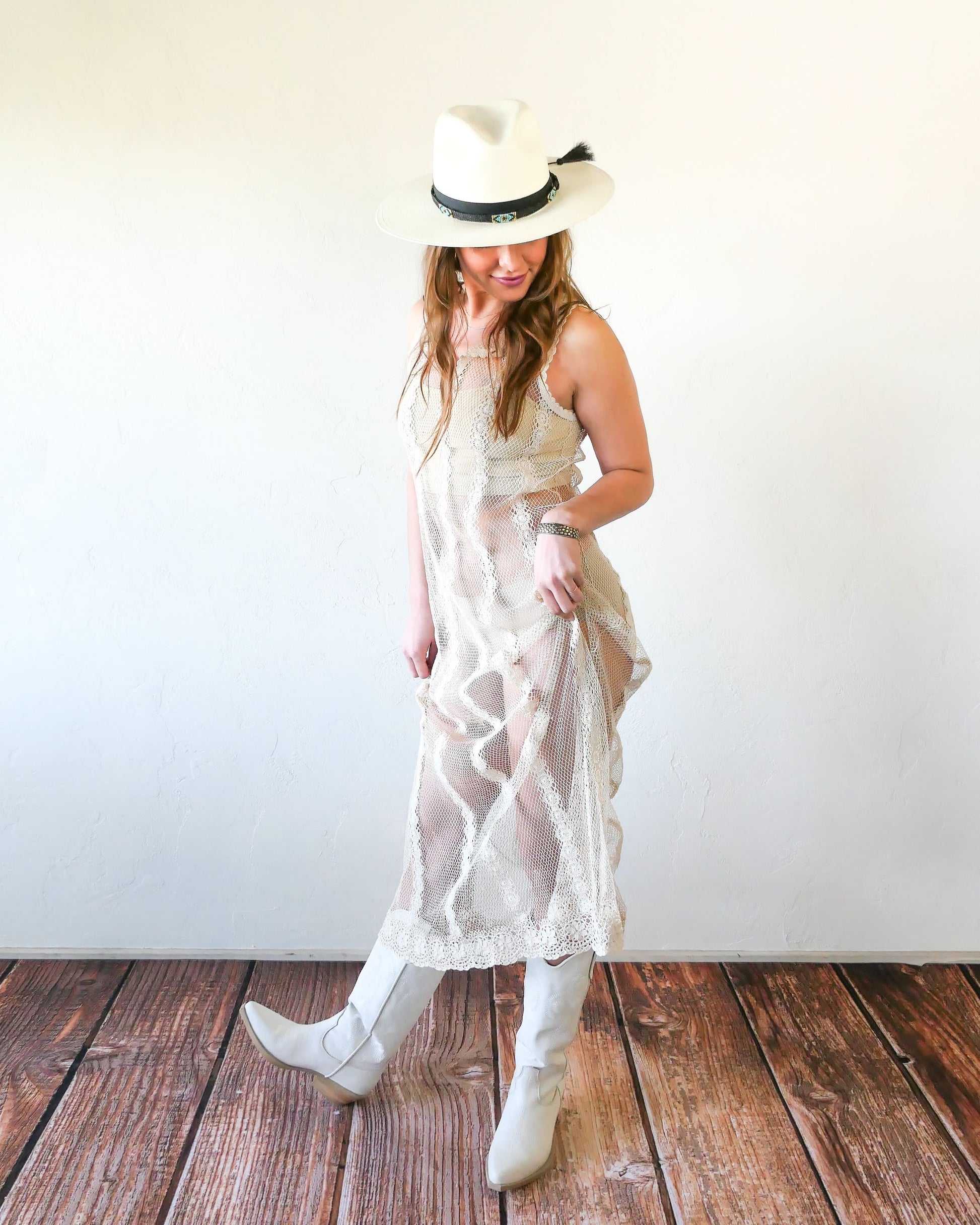 A Lim's crochet fishnet tank maxi dress in Natural with vertical stripes composed of connected pinwheel-like circles. Versatile, lightweight, and an easy pullover dress that is reversible and can be worn with the buttons in the front or back. Perfect as a beach coverup, with boots and a cowgirl hat for that boho chic appeal or worn with a neutral slip and heels for a more sophisticated look. Size: Small to medium Measurements: Bust 32"- 36" Waist 46" Length 51" Hip 50"