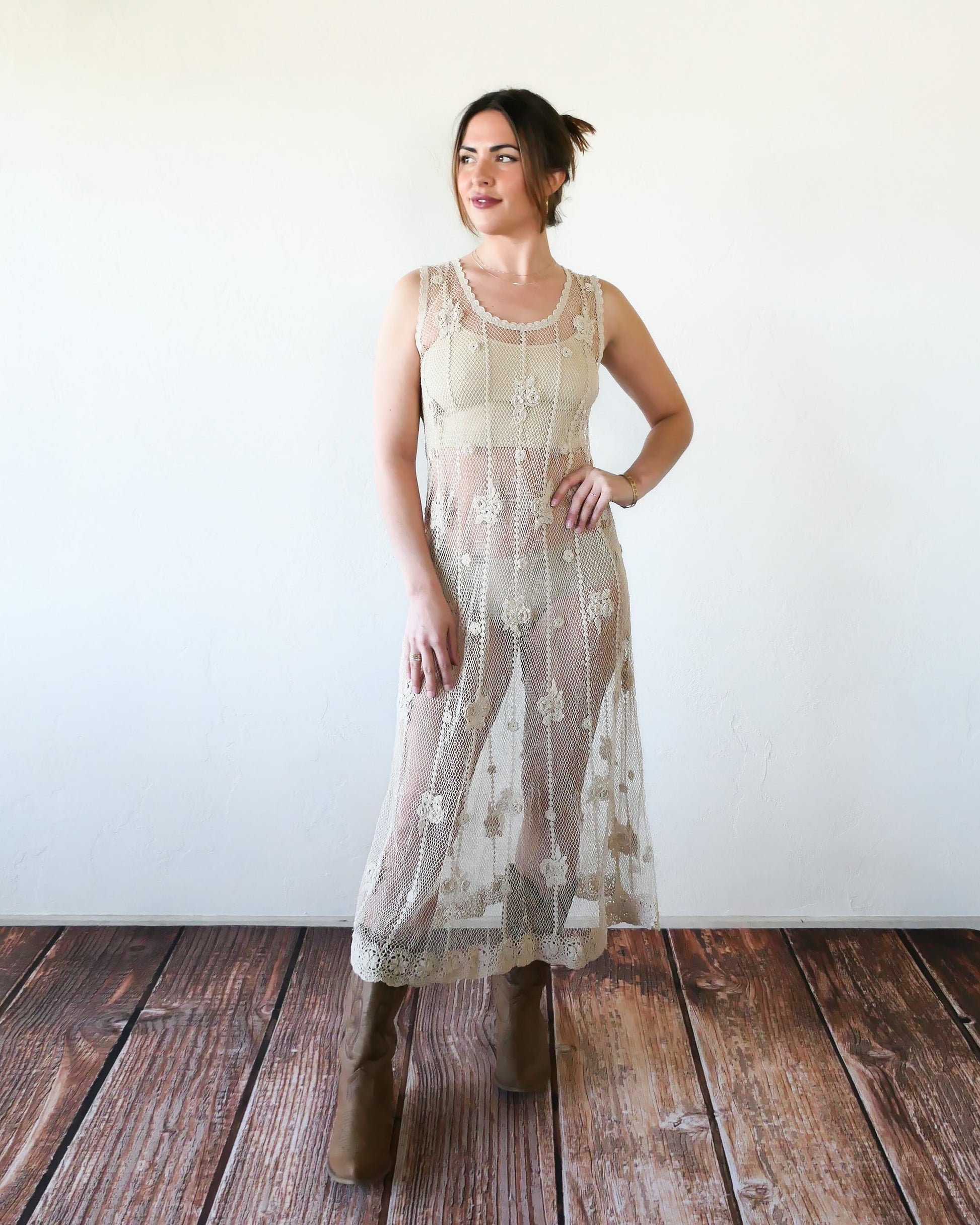 A classic Lim's crochet fishnet tank maxi dress in Natural with vertical stripes and dainty floral clusters throughout. Versatile, lightweight, and an easy pullover dress that is reversible and can be worn with the buttons in the front or back. Perfect as a beach coverup, with boots and a cowgirl hat for that boho chic appeal or worn with a neutral slip and heels for a more sophisticated look.  Size: Fits Small to Medium  