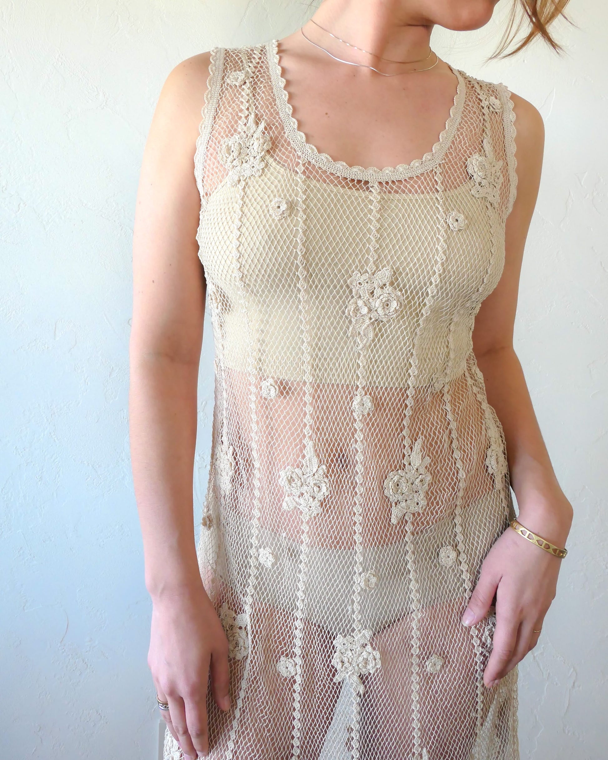A classic Lim's crochet fishnet tank maxi dress in Natural with vertical stripes and dainty floral clusters throughout. Versatile, lightweight, and an easy pullover dress that is reversible and can be worn with the buttons in the front or back. Perfect as a beach coverup, with boots and a cowgirl hat for that boho chic appeal or worn with a neutral slip and heels for a more sophisticated look. Size: Fits Small to Medium