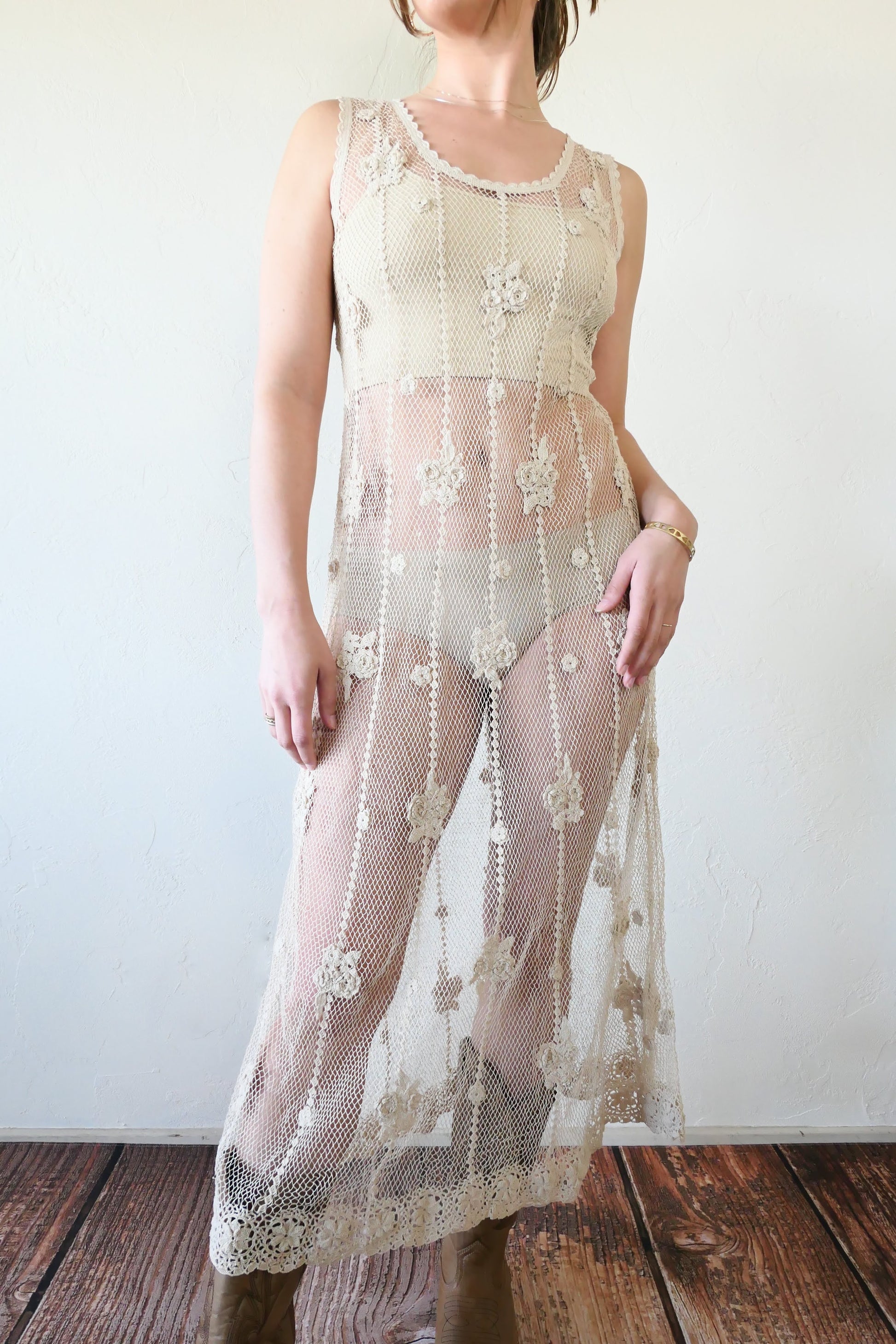 A classic Lim's crochet fishnet tank maxi dress in Natural with vertical stripes and dainty floral clusters throughout. Versatile, lightweight, and an easy pullover dress that is reversible and can be worn with the buttons in the front or back. Perfect as a beach coverup, with boots and a cowgirl hat for that boho chic appeal or worn with a neutral slip and heels for a more sophisticated look. Size: Fits Small to Medium