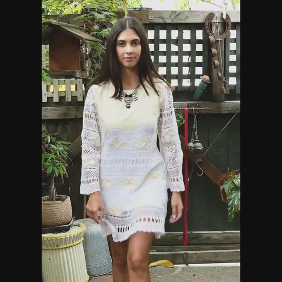 Video. Natural raw silk and artisan hand crochet detail intermix in this mini dress with flared bell sleeves and a comfortable fit. This boho chic dress zips up the back, tapers in at the waist, and is perfect as a beach coverup or a highlight to your vintage wardrobe. Pair it with sandals, or sass it up with cowboy boots and a bold, vintage necklace. Colors: Natural color raw silk and white crochet
