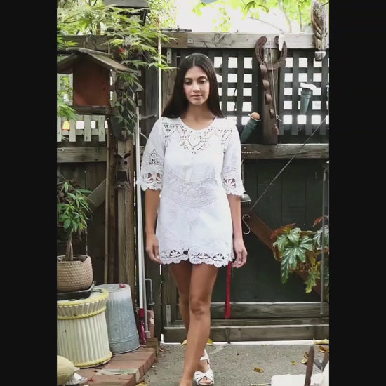 Video of model in white mixed crochet and patchwork embroidered tablecloth mini dress with 1/2 sleeves. By Lim's Vintage.