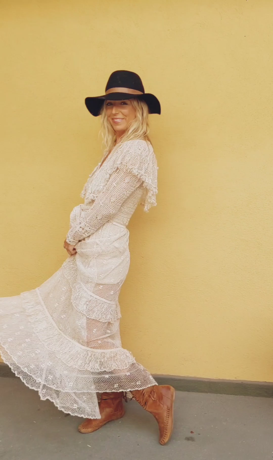 Our one-of-a-kind Lim's original hand crocheted maxi dress from the 1980s, worn by Jane Fonda and once even copied by a famous designer (who shall not be named here) and placed in a major fashion magazine ad. We have only two originals of this dress left in Small and Medium sizes.  Ruffles around the collar line and a two-tiered ruffle at the bottom hem add a boho chic, feminine touch.  The dress is reversible and can be worn with the buttons going up the front or back of the dress.