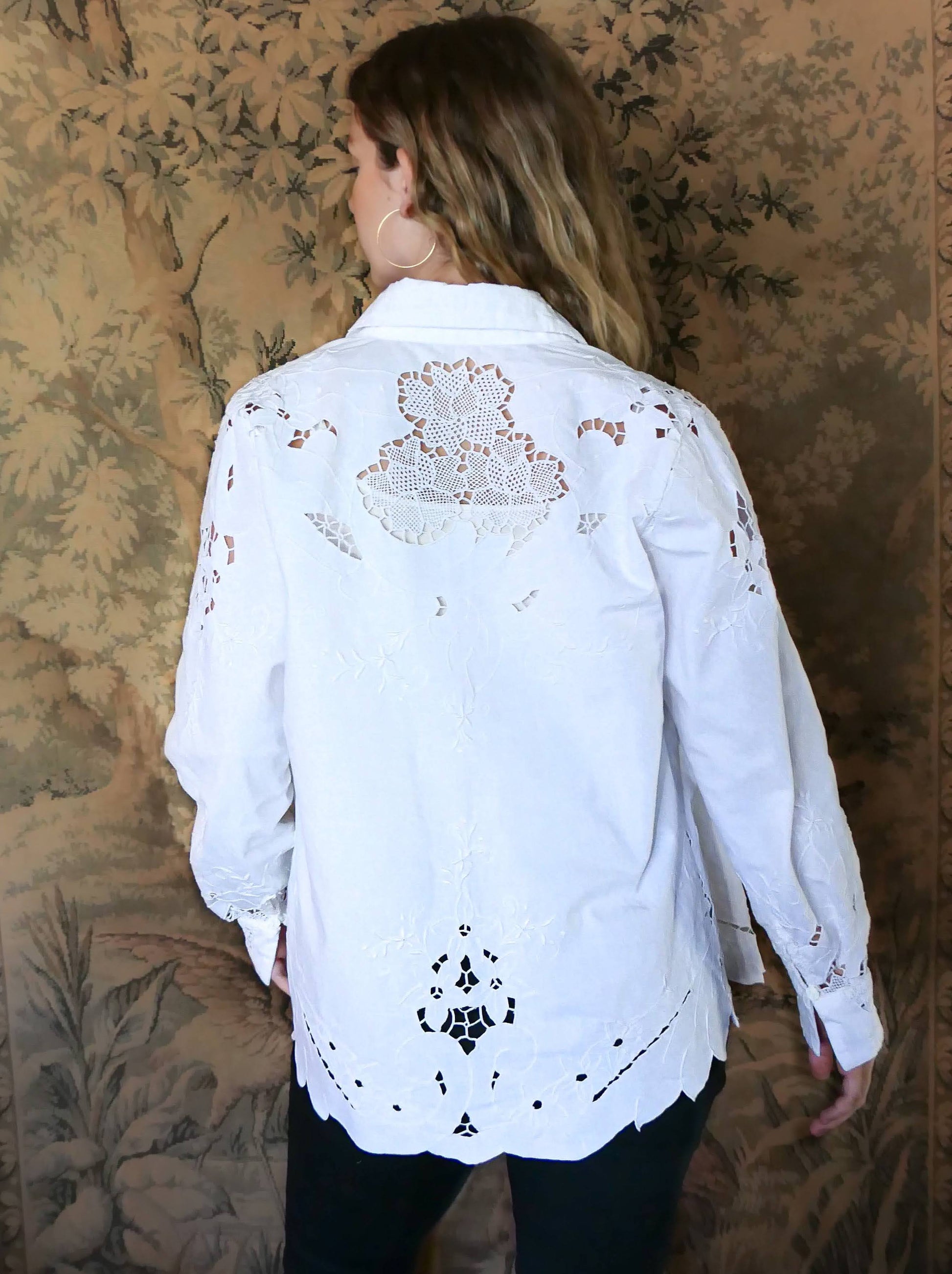 Uplift your everyday wardrobe with this cotton long sleeve shirt made with our vintage cutout and hand embroidered fabric. Embroidered and cutout detail in the collar, cuffs, and hemline make this shirt ultra-feminine and unique.  Note that the fabric is made with a thicker cotton fabric.  Comes in Small, Medium, and Large sizes.  
