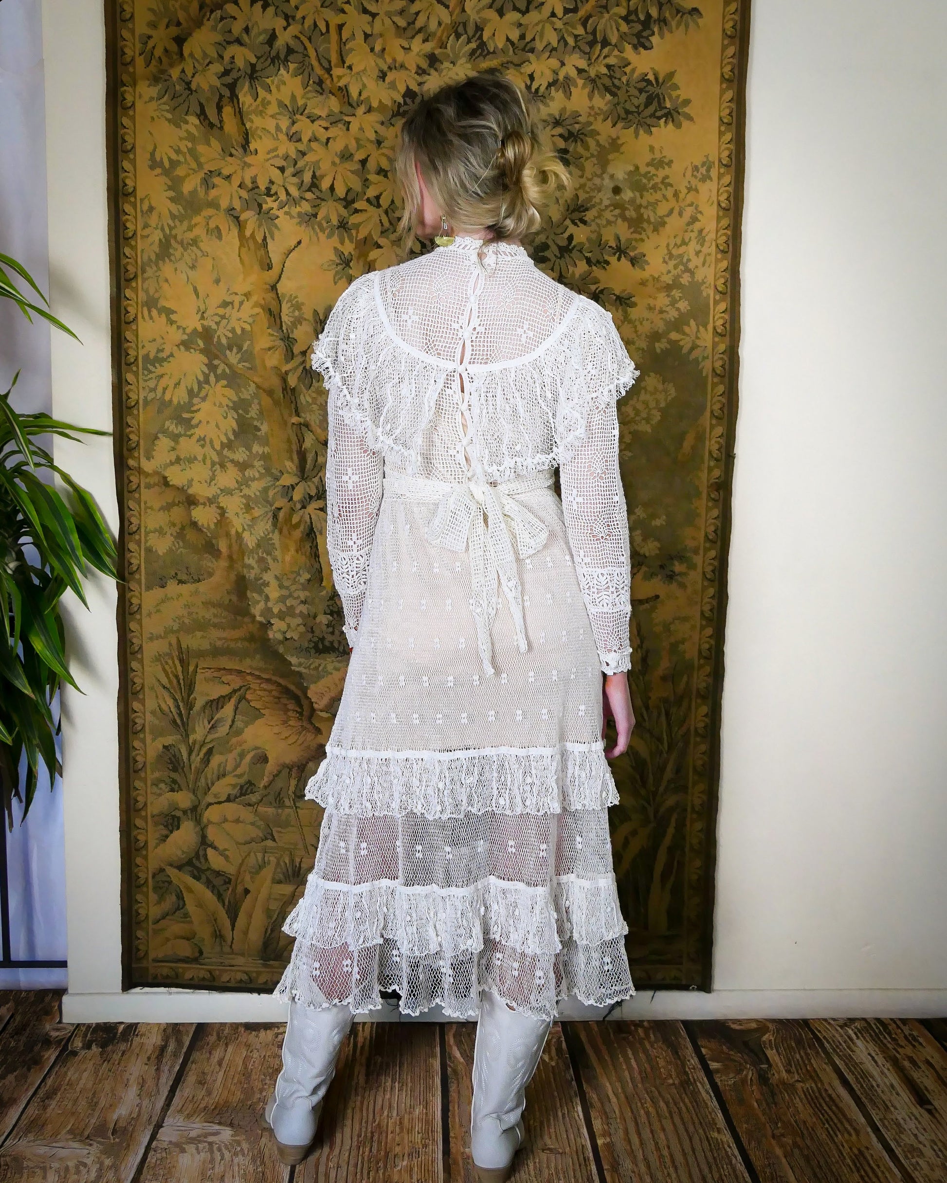 back view of white Lim's crochet maxi dress with ruffles at collar and two-tiered ruffle hem.  