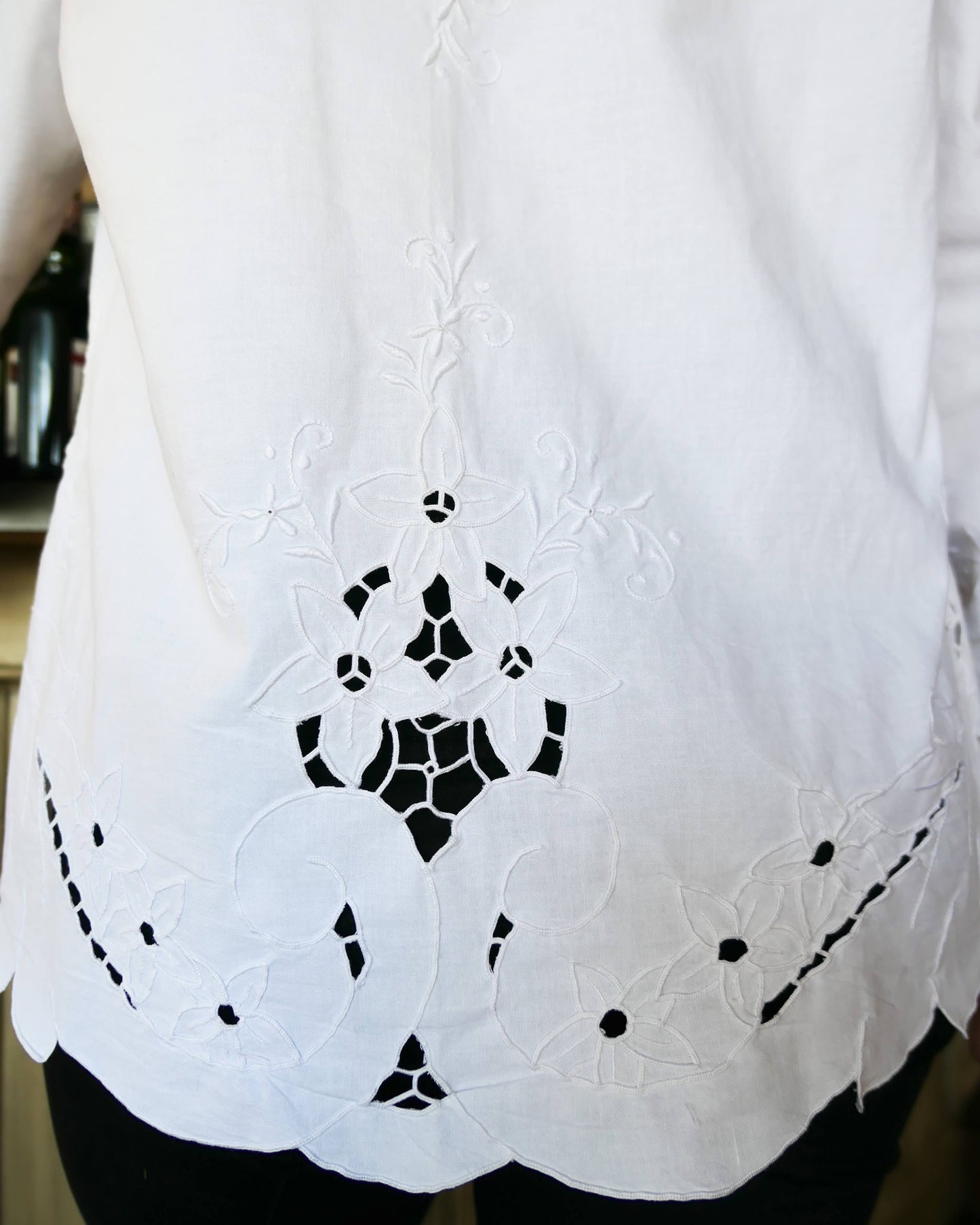 Uplift your everyday wardrobe with this cotton long sleeve shirt made with our vintage cutout and hand embroidered fabric. Embroidered and cutout detail in the collar, cuffs, and hemline make this shirt ultra-feminine and unique.  Note that the fabric is made with a thicker cotton fabric.  Comes in Small, Medium, and Large sizes.  