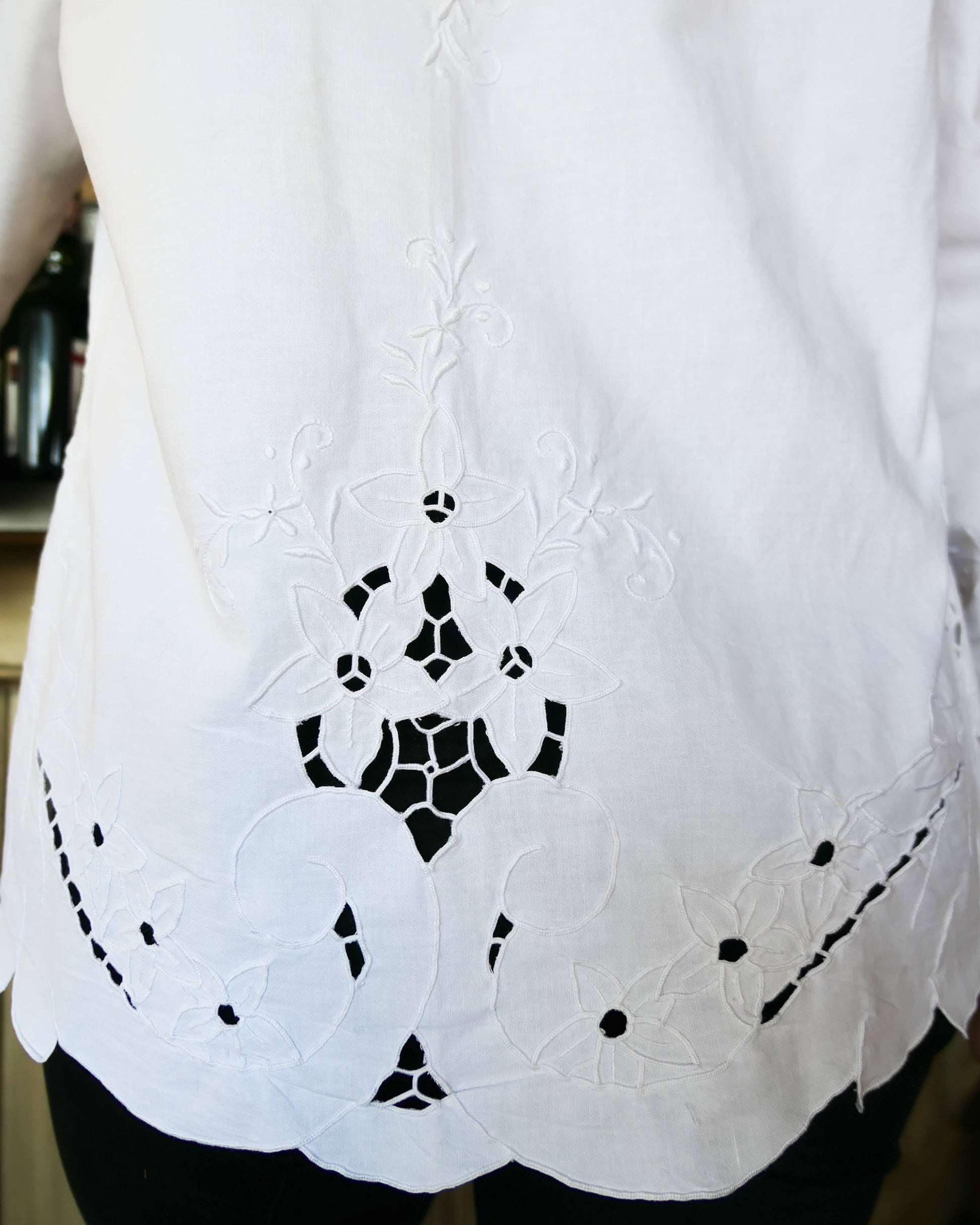 Uplift your everyday wardrobe with this cotton long sleeve shirt made with our vintage cutout and hand embroidered fabric. Embroidered and cutout detail in the collar, cuffs, and hemline make this shirt ultra-feminine and unique.  Note that the fabric is made with a thicker cotton fabric.  Comes in Small, Medium, and Large sizes.  
