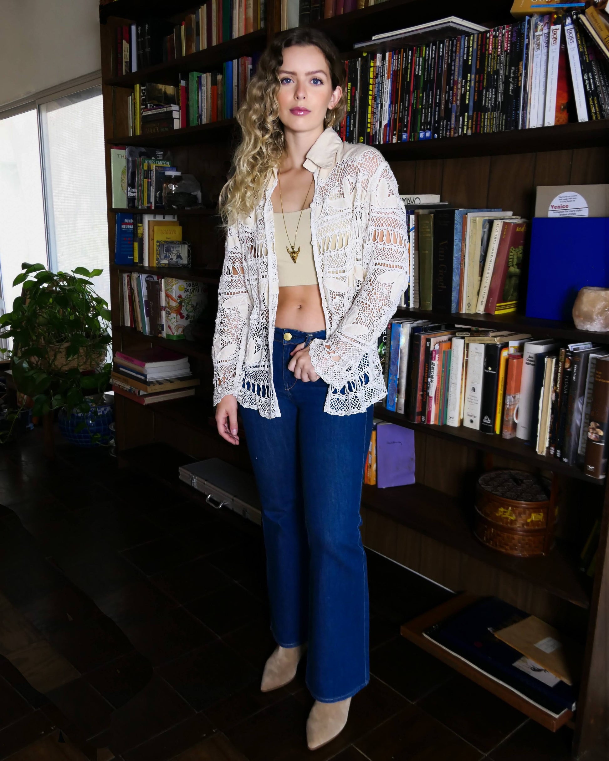 The perfect beach coverup top for your next getaway. An oversized hand crocheted button down top embellished with raw silk leaf-like cutouts. Looks great with a bralette and jeans, or a pair of white wide leg cotton pants, a straw hat, and flip flops.