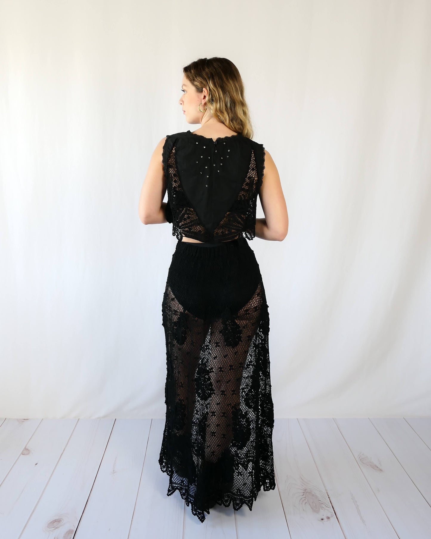 Hand crocheted, lightweight, flowy maxi length slip-on skirt with a comfortable elastic waist and a paisley and floral motif throughout. Makes for a great beach coverup! This is one of our original Lim’s crochet skirts from the 1990s.    Measurements:  X-Small to Small:  Waist 22"- 28" Length 38"  Hip 46" Medium to Large:  Waist 28"- 36" Length 38" Hip 50" Color: Black  Material: 100% cotton   