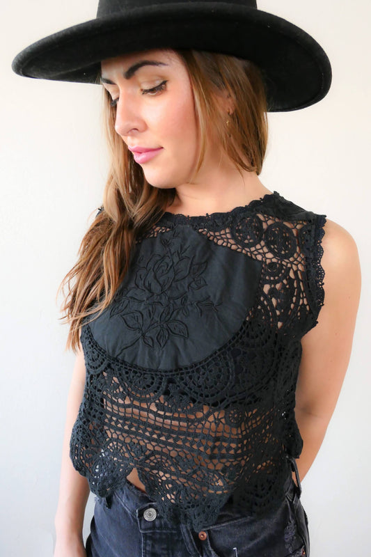Get ready to rock and roll with our vintage crochet and embroidered patchwork crop tank top that has both an edgy and feminine vibe. We've used one of our vintage rose motif embroidered patchwork fabrics to make this limited edition, one-of-a-kind top. Looks great with a pair of black jeans, boots, and a cowboy hat.