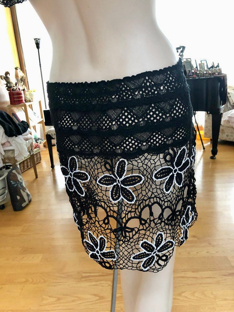 Whimsical daisy flower motif  two-piece top and skirt set made with original Lim's hand crocheted fabric from the 80's.  The skirt has a very comfortable, elastic material around the hips and waist for an easy fit.     Size:  Fits Small to Medium  Measurements:  Bust 34" Top length 19" Waist 26" -30" (elastic) Skirt length 17" Hip 42" material: 100% cotton  color: Black