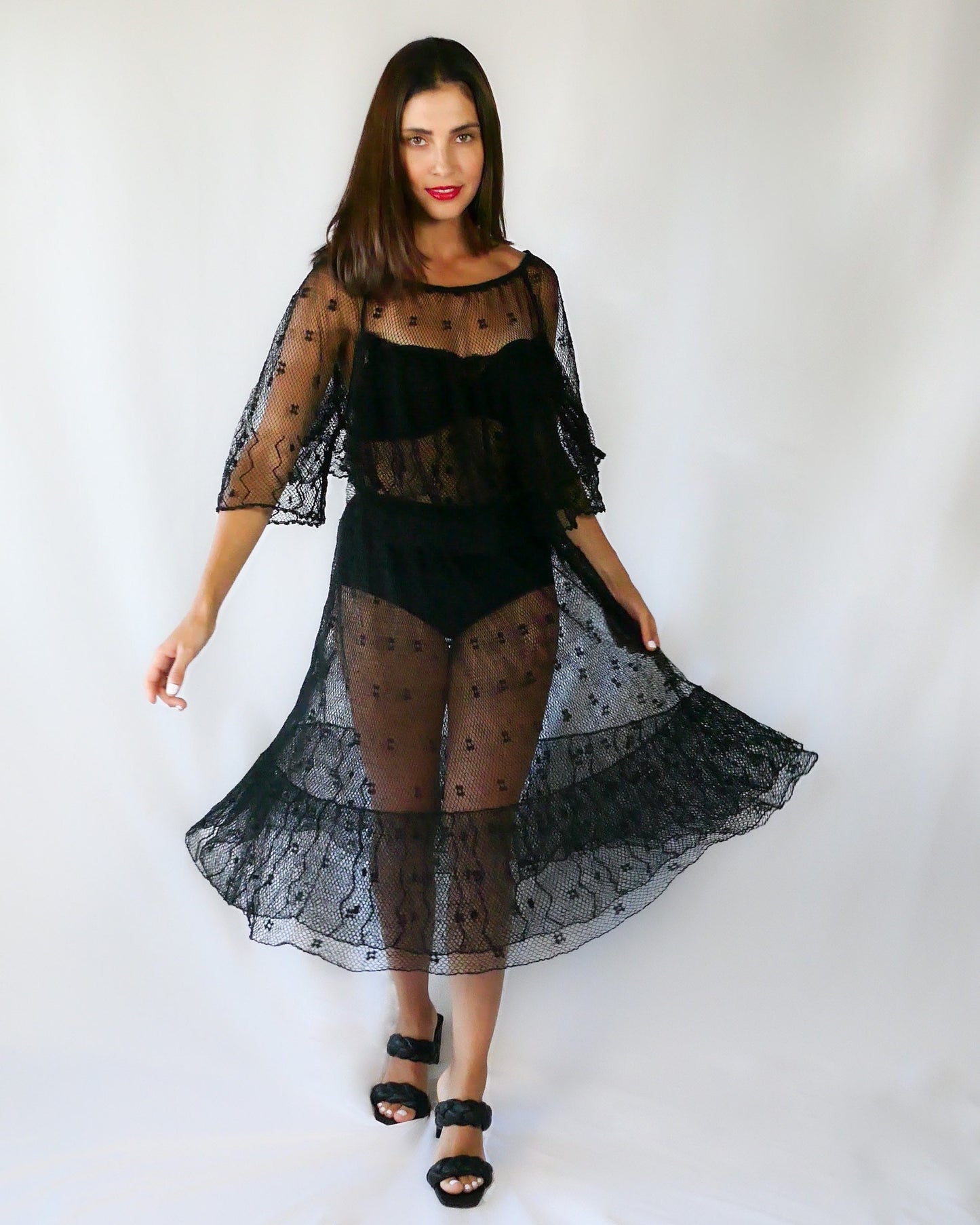 Get some Oohs and Aahs with this one-of-a-kind black sheer crochet party dress!  We combined our vintage Lim's crochet pieces to make this flirty, sensual dress with double semi-ruffle layers all around the front and back collar as well as at the hems.   The dress has a wide crew neck and 3/4 length angel sleeves.   The crochet is stretchable and gives. 