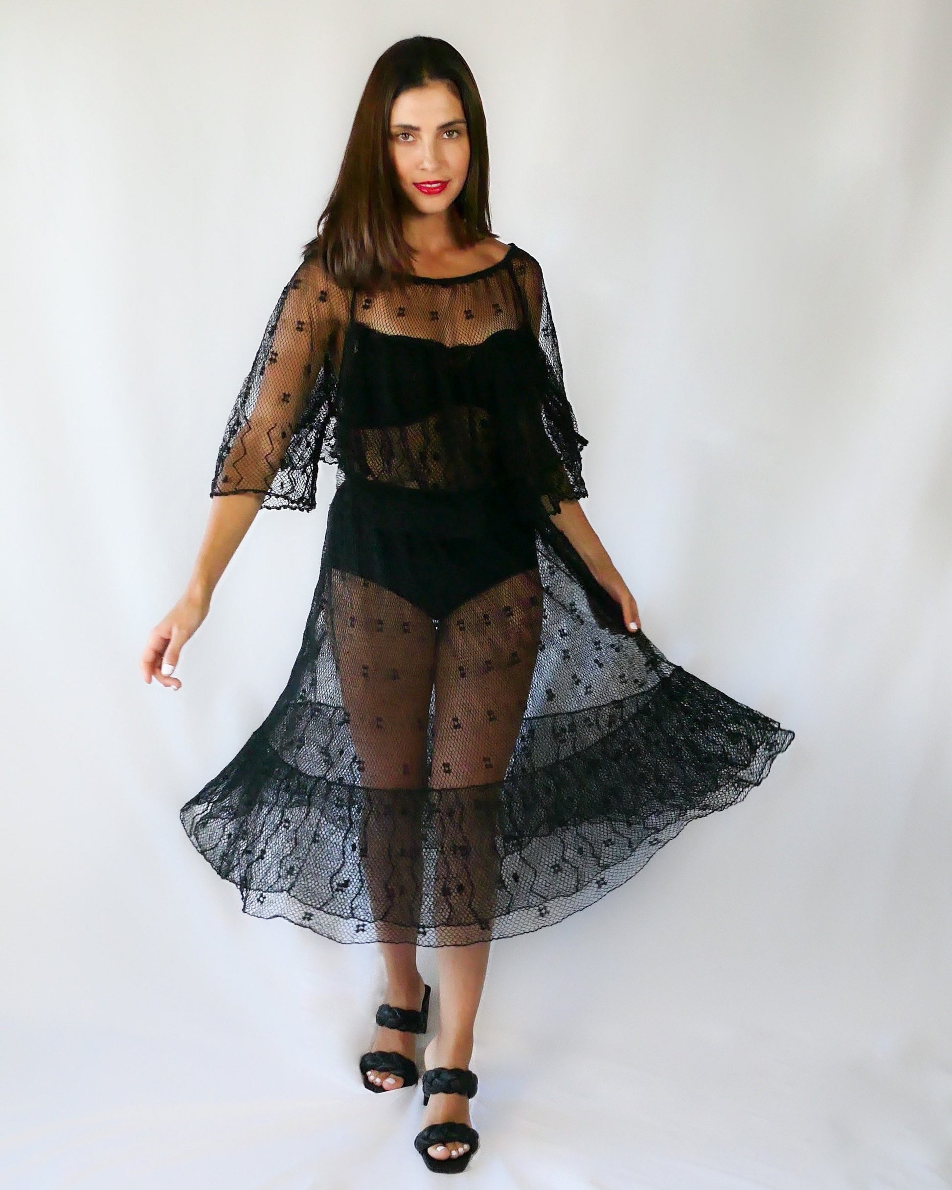 Get some Oohs and Aahs with this one-of-a-kind black sheer crochet party dress!  We combined our vintage Lim's crochet pieces to make this flirty, sensual dress with double semi-ruffle layers all around the front and back collar as well as at the hems.   The dress has a wide crew neck and 3/4 length angel sleeves.   The crochet is stretchable and gives. 