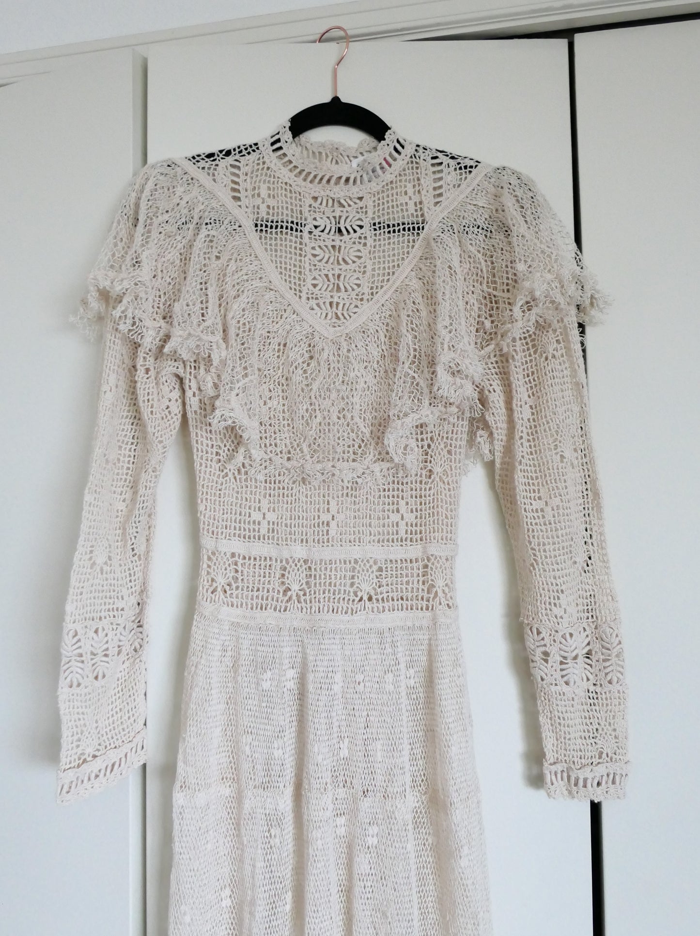 Our one-of-a-kind Lim's original hand crocheted maxi dress from the 1980s, worn by Jane Fonda and once even copied by a famous designer (who shall not be named here) and placed in a major fashion magazine ad. We have only two originals of this dress left in Small and Medium sizes.  Ruffles around the collar line and a two-tiered ruffle at the bottom hem add a boho chic, feminine touch.  The dress is reversible and can be worn with the buttons going up the front or back of the dress.