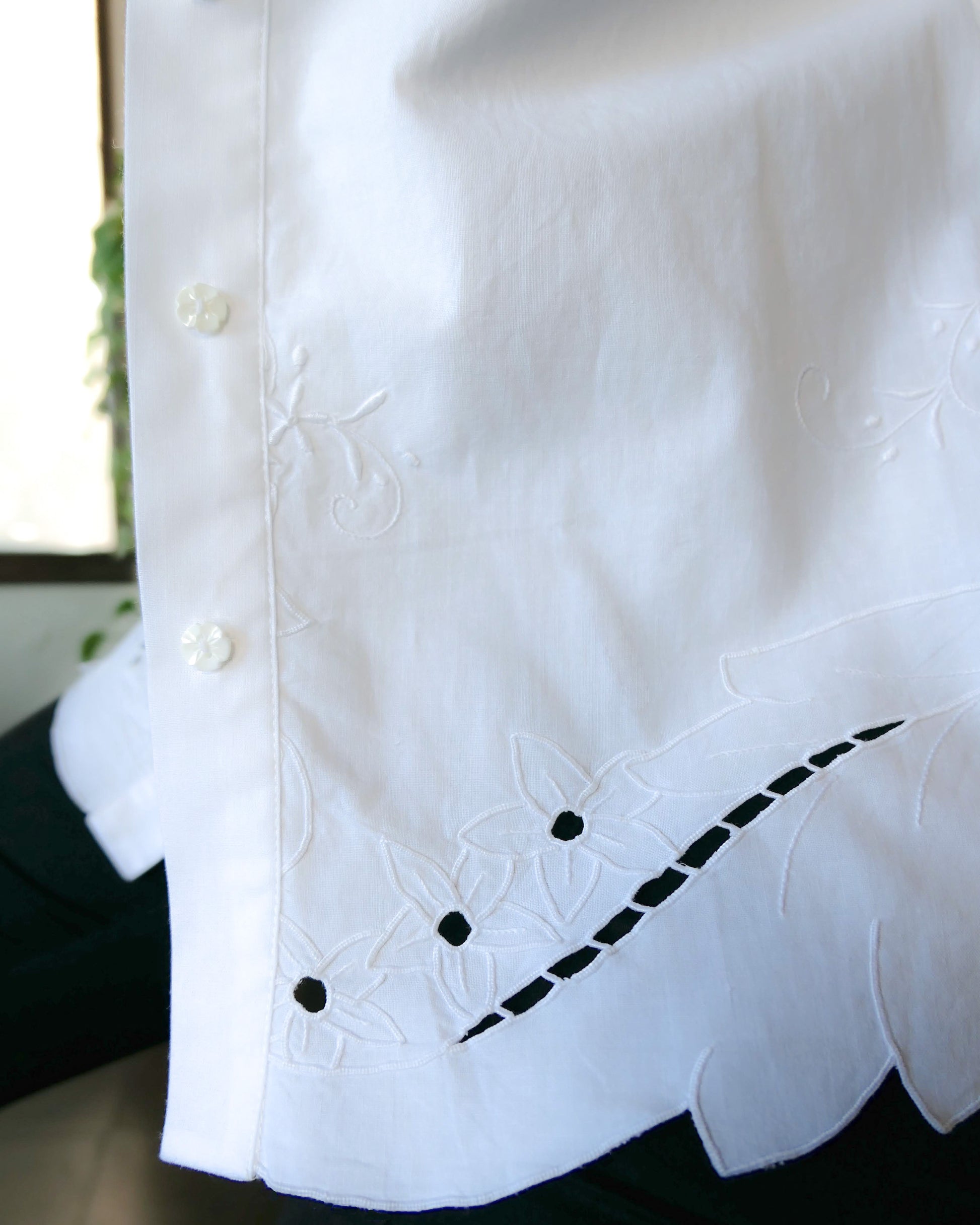 Uplift your everyday wardrobe with this cotton long sleeve shirt made with our vintage cutout and hand embroidered fabric. Embroidered and cutout detail in the collar, cuffs, and hemline make this shirt ultra-feminine and unique.  Note that the fabric is made with a thicker cotton fabric.  Comes in Small, Medium, and Large sizes.  